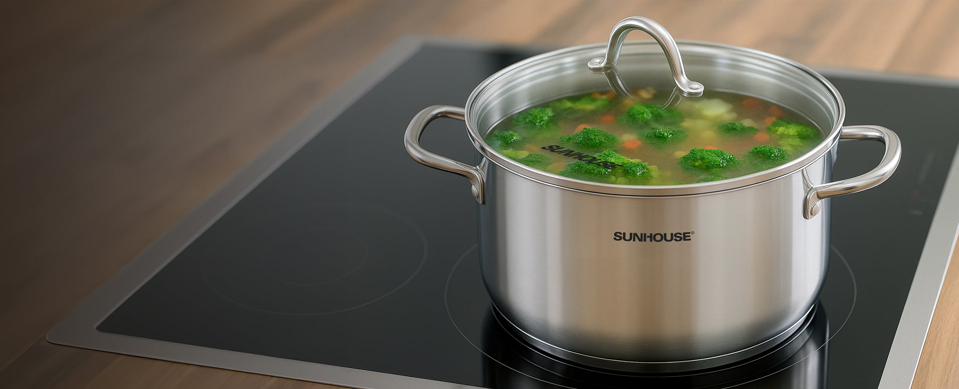 Stainless steel pot with soup on a Sunhouse cooktop