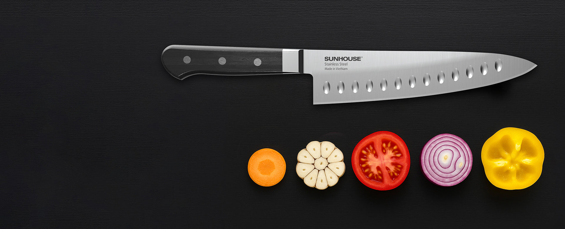 Sunhouse Knife with sliced vegetables on a black background