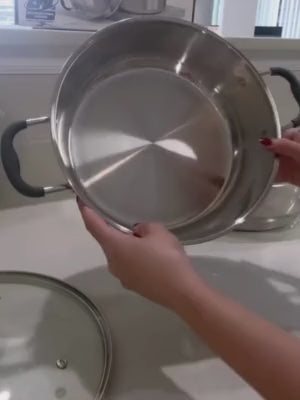 Load video: Sunhouse vegetable steamer with vegetables inside on a white background